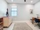 Neutral colored home office with a window, desk, and neutral decor, perfect for productive work from home at 18510 Midsummer Pl, Venice, FL 34293