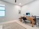 Bright home office with window, desk, and neutral decor, ready for productive work from home at 18510 Midsummer Pl, Venice, FL 34293
