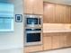 Kitchen featuring stainless steel appliances, including built-in microwave and oven at 18510 Midsummer Pl, Venice, FL 34293