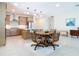 Open-concept kitchen and dining area with modern appliances, countertops, and a kitchen island at 18510 Midsummer Pl, Venice, FL 34293
