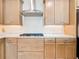 Kitchen featuring stainless steel appliances, gas cooktop, and light wood cabinets at 18510 Midsummer Pl, Venice, FL 34293