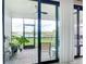 Screened lanai with view of the lake with outdoor seating and lush plants, blending indoor and outdoor living at 18510 Midsummer Pl, Venice, FL 34293