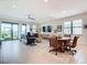 Spacious living room with sliding glass doors, large windows, a ceiling fan and comfortable seating at 18510 Midsummer Pl, Venice, FL 34293