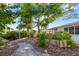 A backyard featuring lush greenery, a wooden walkway, and partial views of the waterfront at 1921 Fairview Dr, Englewood, FL 34223