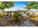 Charming backyard featuring a cozy patio area, fire pit, and lush greenery at 1921 Fairview Dr, Englewood, FL 34223