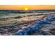 Beautiful beach view with waves crashing and sun setting over the ocean horizon at 1921 Fairview Dr, Englewood, FL 34223