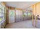 Bright dining room featuring exposed walls, ceiling lights and exterior door at 1921 Fairview Dr, Englewood, FL 34223