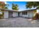 Light green single story home features a quaint entrance, garage, and an inviting curb appeal at 1921 Fairview Dr, Englewood, FL 34223