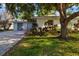 Charming single-story home with lush landscaping, a driveway, and an inviting curb appeal at 1921 Fairview Dr, Englewood, FL 34223