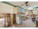Spacious kitchen area featuring light blue cabinets, tile countertops and flooring, and an open design concept at 1921 Fairview Dr, Englewood, FL 34223