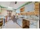 Outdated kitchen featuring light blue cabinetry and view into adjoining room at 1921 Fairview Dr, Englewood, FL 34223