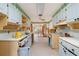 Retro kitchen featuring light blue cabinetry and open view into adjoining room at 1921 Fairview Dr, Englewood, FL 34223