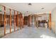 Room with exposed walls, ceiling lights and view into unfinished bathroom at 1921 Fairview Dr, Englewood, FL 34223