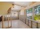Unfinished living room featuring large windows, concrete block construction, and tile flooring at 1921 Fairview Dr, Englewood, FL 34223