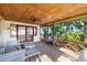 Inviting screened porch with a wood ceiling, fan, and comfortable seating provides a relaxing outdoor space at 1921 Fairview Dr, Englewood, FL 34223
