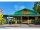 Colorful restaurant exterior, with outdoor seating, palm trees, and easy pedestrian access at 1921 Fairview Dr, Englewood, FL 34223