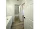 Clean bathroom with a white-tiled shower and tub at 1947 Los Lomas Dr, Clearwater, FL 33763