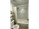 The modern bathroom includes a shower over tub and geometric tiles at 1947 Los Lomas Dr, Clearwater, FL 33763