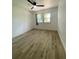 Cozy bedroom with new floors, ceiling fan and natural light at 1947 Los Lomas Dr, Clearwater, FL 33763