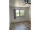 A bedroom featuring hardwood floors, a large window, and ample natural light at 1947 Los Lomas Dr, Clearwater, FL 33763