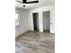This bedroom has hardwood floors, a closet, a ceiling fan, and is freshly painted at 1947 Los Lomas Dr, Clearwater, FL 33763