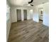 A bright bedroom leads to a bathroom and features hardwood floors at 1947 Los Lomas Dr, Clearwater, FL 33763
