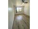 Bedroom with hardwood floors, a window, and a ceiling fan provides a cozy retreat at 1947 Los Lomas Dr, Clearwater, FL 33763