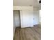 This bright bedroom features light hardwood floors and a spacious closet at 1947 Los Lomas Dr, Clearwater, FL 33763