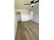 This bright bedroom features light hardwood floors, a modern fan, and a closet at 1947 Los Lomas Dr, Clearwater, FL 33763