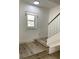 Bright entryway with light wood flooring, a staircase, and a window offering natural light at 1947 Los Lomas Dr, Clearwater, FL 33763