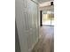 Hallway with closet showing wood-look flooring and a door to the backyard at 1947 Los Lomas Dr, Clearwater, FL 33763