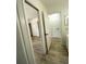 Hallway leading to bedroom with closets and bathroom at 1947 Los Lomas Dr, Clearwater, FL 33763