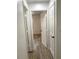 View of a hallway leading into a bedroom with hardwood floors at 1947 Los Lomas Dr, Clearwater, FL 33763