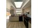 Updated kitchen featuring modern appliances, sleek cabinets, butcher block countertops, and ample natural light at 1947 Los Lomas Dr, Clearwater, FL 33763