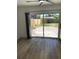 Living room with new floors and a glass sliding door leads to a private backyard area at 1947 Los Lomas Dr, Clearwater, FL 33763
