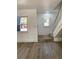 Open-concept living room with a staircase and view of front door entrance at 1947 Los Lomas Dr, Clearwater, FL 33763