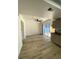 Well-lit living room with a view into kitchen, access to the backyard and new flooring at 1947 Los Lomas Dr, Clearwater, FL 33763