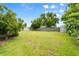 Expansive backyard with mature trees, providing ample shade and privacy at 2015 Bayshore Gardens Pkwy, Bradenton, FL 34207
