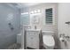 Modern bathroom featuring a walk-in shower with textured tile and a comfort height toilet at 2015 Bayshore Gardens Pkwy, Bradenton, FL 34207