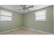 Small bedroom featuring tile flooring, ceiling fan, and louvered windows at 2015 Bayshore Gardens Pkwy, Bradenton, FL 34207