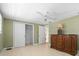 Bedroom with tile floors, closet, and decorative dresser with lamp at 2015 Bayshore Gardens Pkwy, Bradenton, FL 34207