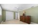 Bedroom with tile floors, closet, dresser, and ceiling fan at 2015 Bayshore Gardens Pkwy, Bradenton, FL 34207