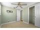 Cozy bedroom with closet and adjacent door with ceiling fan at 2015 Bayshore Gardens Pkwy, Bradenton, FL 34207