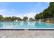 Large community pool with a shallow end, lifeguard stand, and well-maintained surroundings for safe enjoyment at 2015 Bayshore Gardens Pkwy, Bradenton, FL 34207