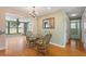 Cozy dining area with a glass table, chandelier lighting, and views of the screened in porch at 2015 Bayshore Gardens Pkwy, Bradenton, FL 34207