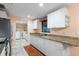 The kitchen has granite countertops, white cabinets, and flows into the laundry room for added convenience at 2015 Bayshore Gardens Pkwy, Bradenton, FL 34207