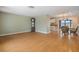 Bright and open living area connects to kitchen and dining spaces, showcasing hardwood floors at 2015 Bayshore Gardens Pkwy, Bradenton, FL 34207