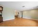 Open living space leads into a dining area, featuring hardwood floors, and fresh paint at 2015 Bayshore Gardens Pkwy, Bradenton, FL 34207