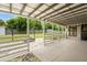 Covered patio leading to a spacious backyard with lush green lawn and storage shed at 2015 Bayshore Gardens Pkwy, Bradenton, FL 34207