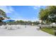Community pool deck with ample seating, umbrellas, and views of the pool area for social gatherings at 2015 Bayshore Gardens Pkwy, Bradenton, FL 34207